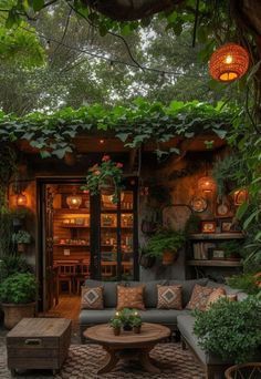 an outdoor living area with couches, tables and potted plants