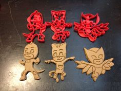 four cookie cutters that are shaped to look like cartoon characters