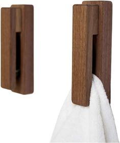 two wooden towel holders with white towels hanging from them