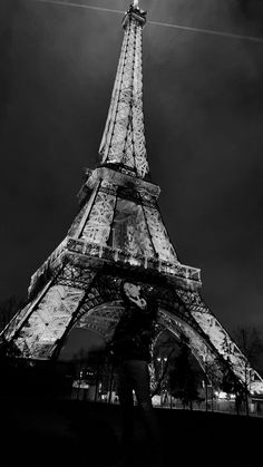 black and white photograph of the eiffel tower in paris, france at night