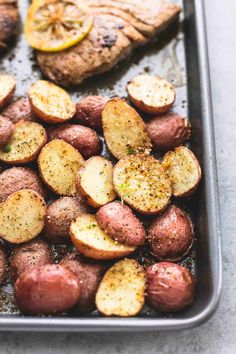 potatoes and meat in a baking pan with seasoning on the side, ready to be cooked