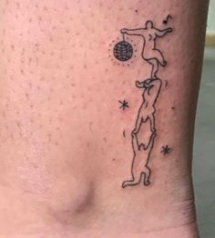 a person with a tattoo on their foot that has a drawing of a man holding a ball