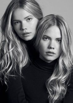 two beautiful young women posing for a black and white photo