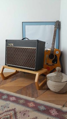 a guitar and amp are sitting on the floor