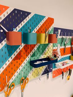 colorful pegboard with scissors hanging on it