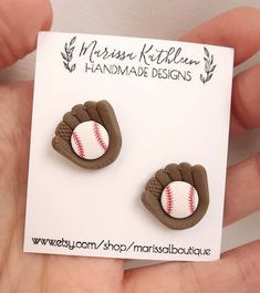 a pair of brown and white baseball mitt earrings