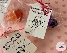 two valentine's day gift bags with tags attached to them