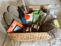 a basket filled with assorted items on top of a bed