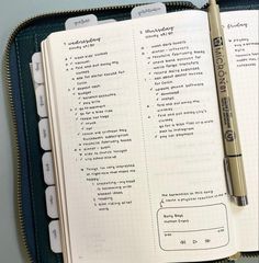 an open notebook with some writing on it and a pen in the top right corner