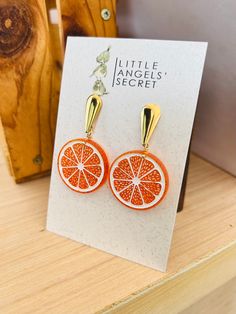 Handmade Acrylic earrings:  orange earrings. Nickel free ear wires Iridescent white acrylic  Size LARGE Height: 1 5/8" (including ear wires) Width:   1 5/8" Size MEDIUM Height: 1 1/2" (including ear wires) Width:   1 1/2"  Size SMALL Height: 1 1/4" (including ear wires) Width:   1 1/4"  Taking care of your jewelry. Please, use a soft and dry piece of fabric and gently rub your earrings. Don't use any kind of cleaner or alcohol. PLEASE BE AWARE: Some of the products (hats, headbands, bows, masks) contain                   small parts, please supervise your children! Orange Slice, Iridescent White, Fruit Earrings, Earrings Summer, Orange Earrings, Summer Earrings, Summer Earring, Orange Slices, White Acrylic