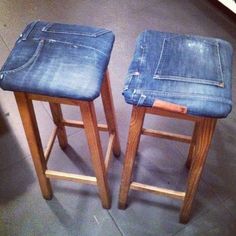 two wooden stools with blue denim upholstered seats