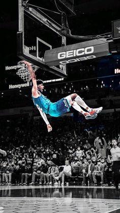 a basketball player is in mid air after dunking the ball