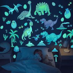 a child's bedroom with dinosaur glow in the dark wall decals