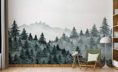 a room with a wall mural that has trees painted on it and a chair in the foreground