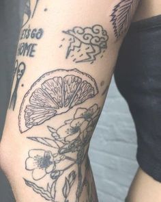 a woman's arm with tattoos on it that has oranges and flowers on it