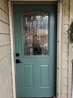 a green front door with a glass window