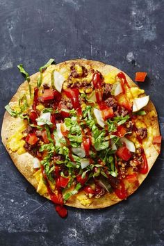 a pizza topped with lots of toppings on top of a table