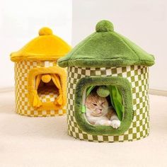 a cat is laying in a house shaped like a dog bed and another one has a green cover over it