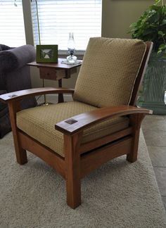 a wooden chair sitting on top of a carpeted floor