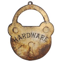 an old rusty padlock with the word hardware hanging from it's center loop