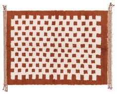 a brown and white rug with squares on the bottom, fringes hanging down from it