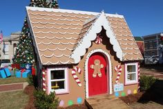 a gingerbread house is decorated with candy canes and christmas decorations on the roof