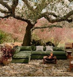 an outdoor seating area with a tree in the background and text that reads, free shipping on orders $ 50