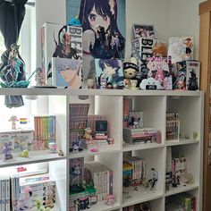 a book shelf filled with lots of anime related items