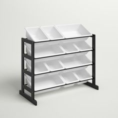 a black and white shelf with bins on it