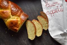 a loaf of bread sitting on top of a table next to a piece of bread