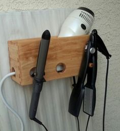 an electric hair dryer is attached to a wooden holder on the wall next to a hairdryer