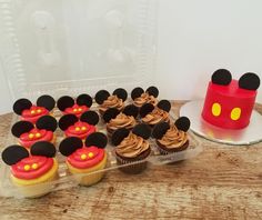 cupcakes with mickey mouse ears are on a table