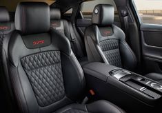 the interior of a car with black leather and red stitching