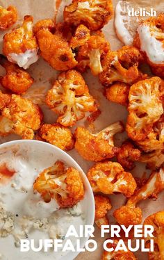 some food is laying out on a table with the words air fryer buffalo cauliflower