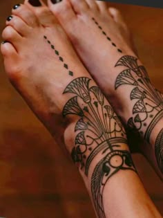 two people with matching tattoos on their feet