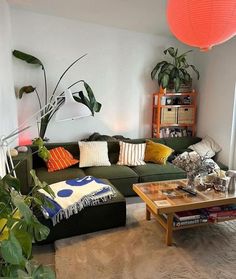 a living room filled with furniture and lots of plants