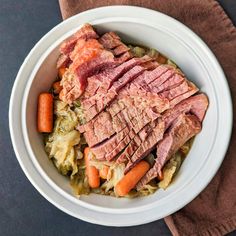 a white bowl filled with meat and vegetables