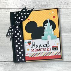 a card with mickey mouse on it and the words,'magical memories'written in black