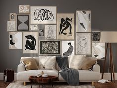 a living room filled with lots of art on the wall above a white couch and coffee table