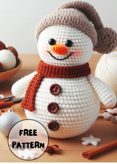 a crocheted snowman sitting on top of a table next to other items