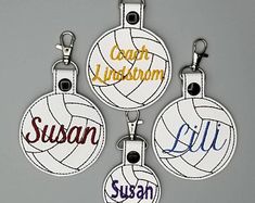 four key chains with different colored volleyballs on them