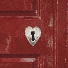 a red door with a heart shaped keyhole