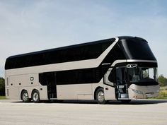 a black and white bus parked on the side of the road