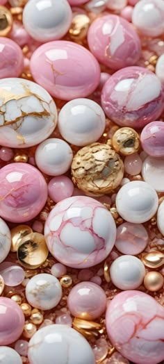 pink and white beads with gold accents are shown in close up view on the surface