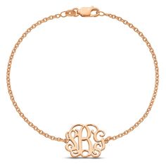 a gold bracelet with the initial monogram on it