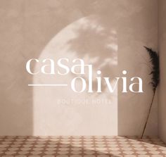 the logo for cassa ollivia boutique hotel is shown in front of an empty room