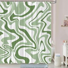 a bathroom with a green and white shower curtain