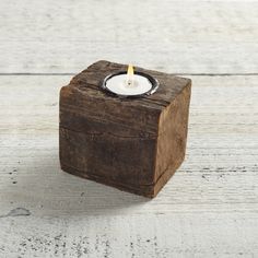 a small wooden block with a candle in it