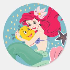 the little mermaid is hugging her baby