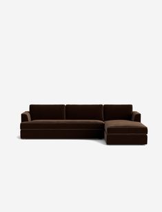 a brown sectional couch sitting on top of a white floor